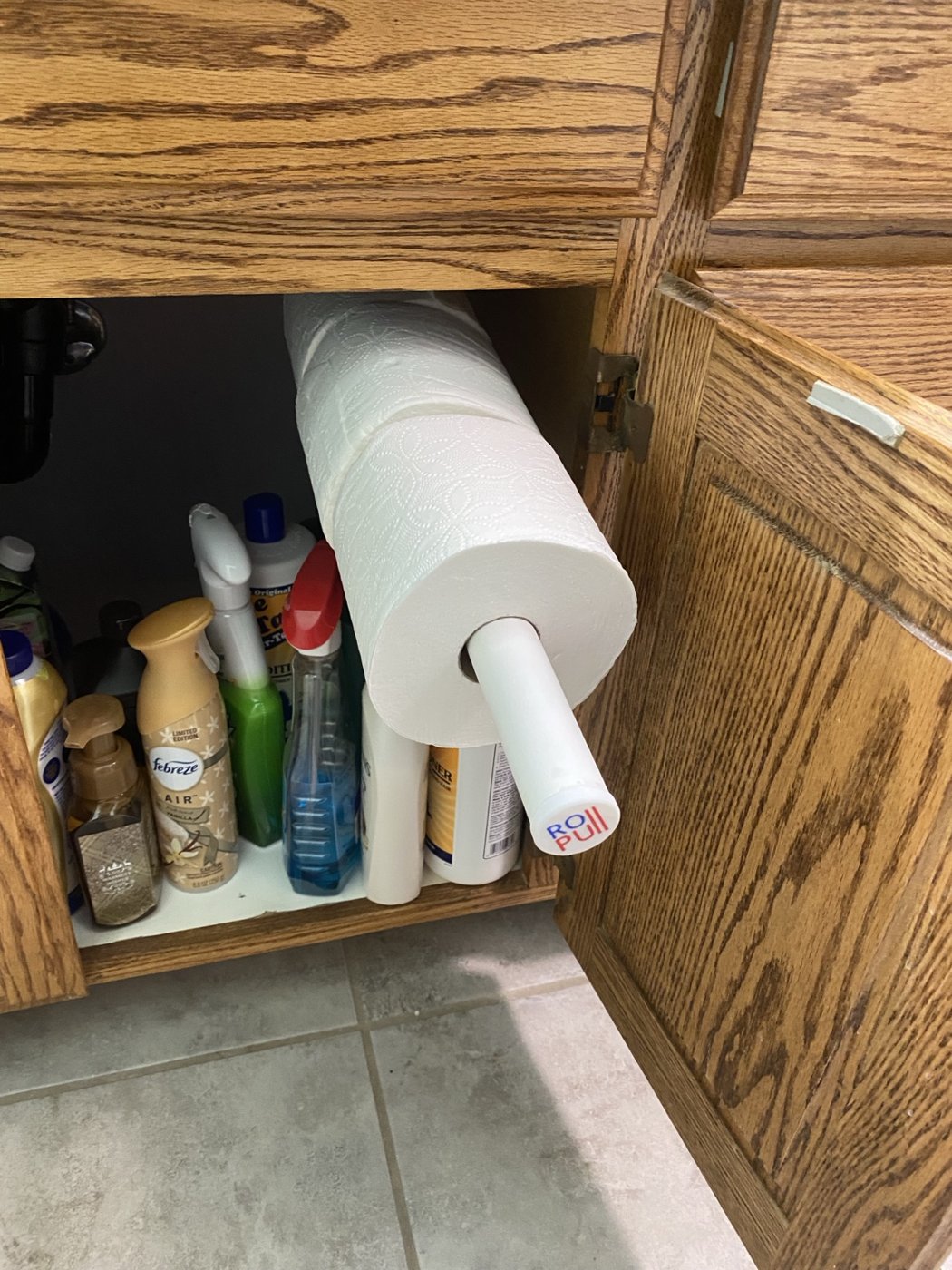 RollPull holding spare rolls inside an under-sink cabinet